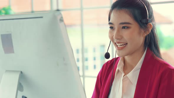 Businesswoman Wearing Headset Working Actively in Office alt