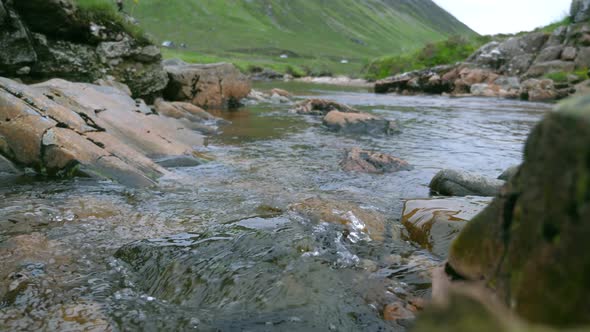 Natural water flows through rocks in highlands alt