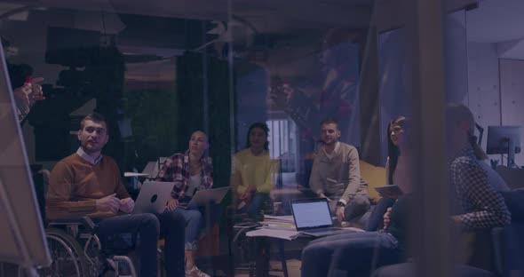 Businesswoman in Wheelchair Having Business Meeting with Team at Modern Office