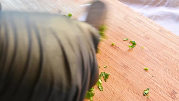 Chef Chopping Fresh Parsley with a Knife Close Up