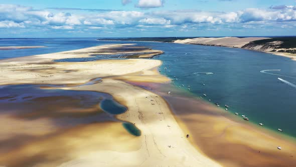 Arcachon Bassin France over Banc d'Arguin with boats anchored on the south passage, Aerial dolly out alt