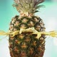 Fresh Pineapple Fruit Squirting and Burst with Juice in Slow Motion in Turquoise Blue Background - VideoHive Item for Sale