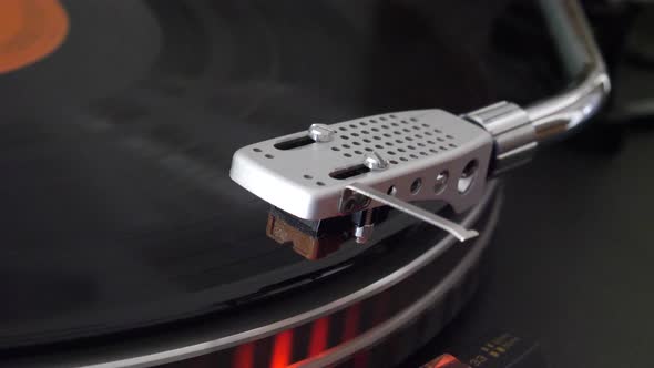 Vintage record player spinning and the needle drops slowly onto the spinning vinyl album and the mus alt
