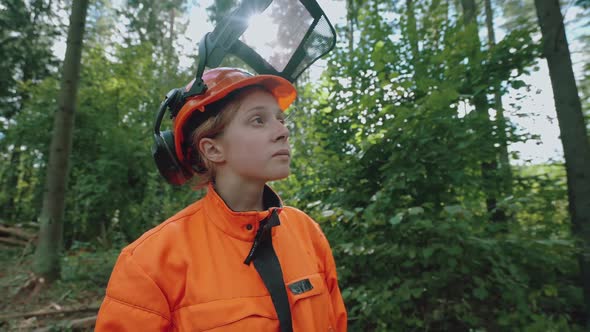 Hard Work Portrait of a Female Logger Standing in the Forest a Young Specialist Woman in Protective alt