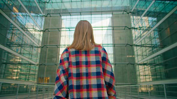 Business Woman Walks in Modern Glass Building Turns to Camera and Smiles