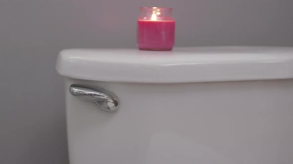 Flushing Clean Toilet With Candle