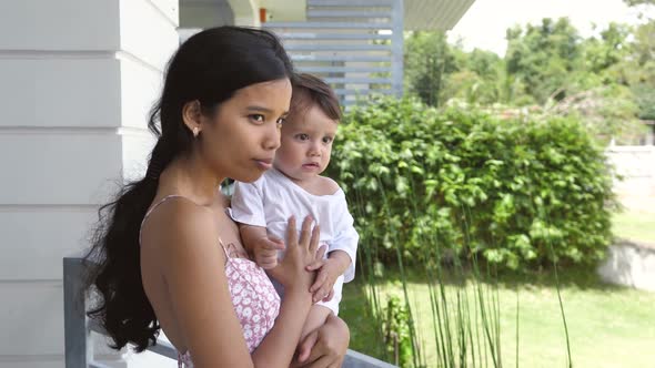 A Swarthy Woman with Gorgeous Black Hair Stands with Her Sweet Handsome Son and Breathes in the alt