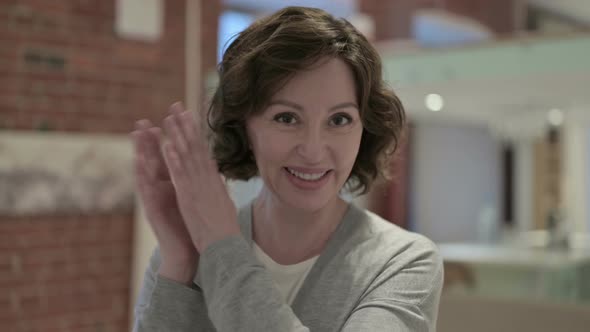 Portrait of Cheerful Old Woman Clapping and Smiling alt