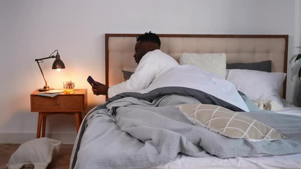 Wide Shot African American Young Man Waking Up Checking Time Hurrying Leaving Bedroom alt