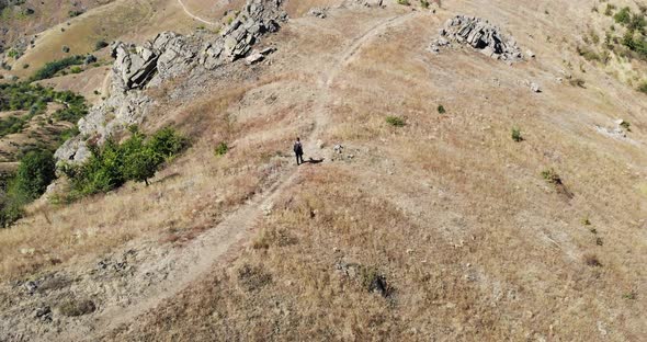Lone Man Walks On Macin Mountain Range In Romania On A Sunny Summer Day alt
