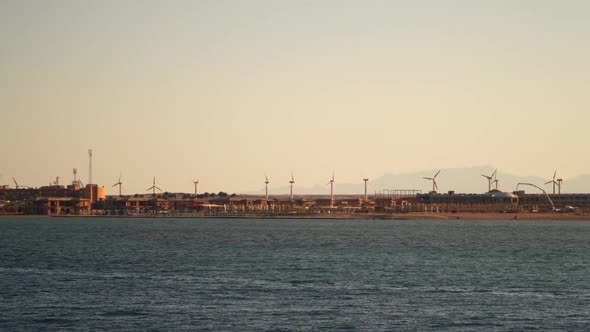 Wind turbines on the coast. View from the sea from the ship