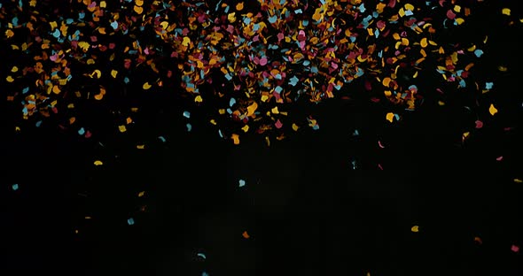 Confetti Falling against Black Background, Slow Motion 4K alt