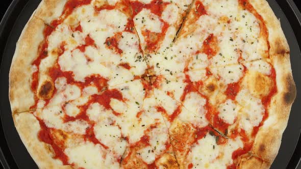 Top View of Fresh Baked Pizza with Tomatoes and Cheese Mozzarella Rotate on Tray alt