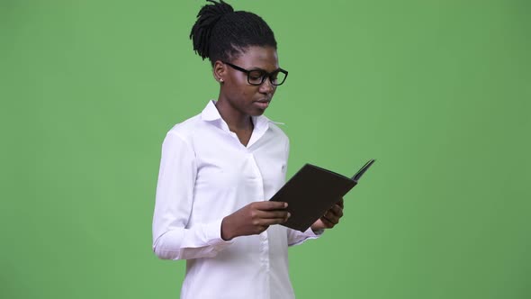 Young Beautiful African Businesswoman Reading Book