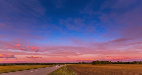 Red Sunset Sky Time Lapse with a Road. Clouds Timelapse Nature Background. Dramatic Evening Color