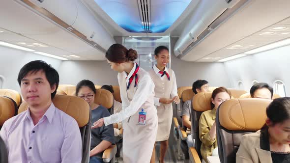 4K Asian woman flight attendant closing luggage compartment before aircraft take off runway. alt