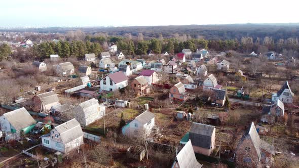 Aerial Drone View Flight Over Small Brick Houses with Plot of Land in the Middle alt