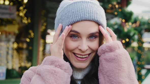 Handheld view of beautiful woman in winter clothes. Shot with RED helium camera in 8K alt