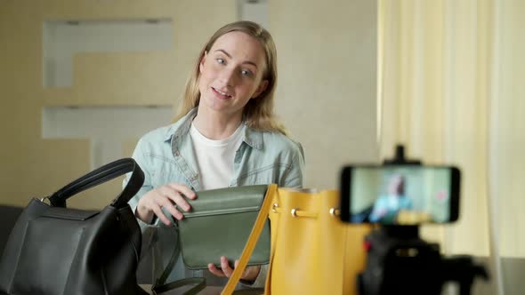 A Female Blogger Shows Fashion Bags Live on Social Media Recording Her Sale Online Using a Digital alt