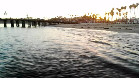 Aerial drone shot low over the Pacific Ocean at sunset off the coast of Santa Barbara with Stearns W alt