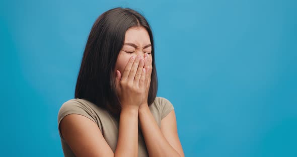 Cough Attack. Studio Shot of Young Asian Woman Coughing Over Blue Background, Free Space alt
