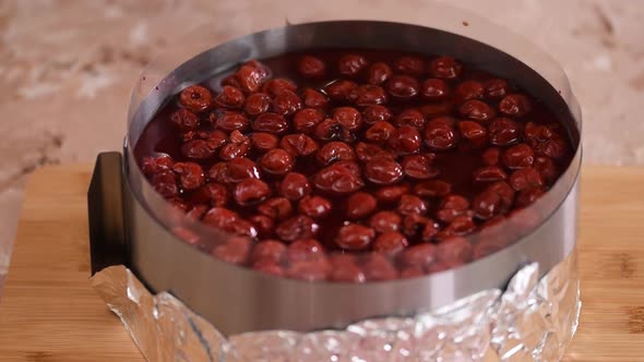 Pouring the Jelly Mixture Over the Cherry Cake