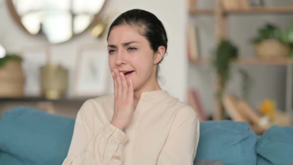 Sleepy Indian Woman Yawning at Home alt