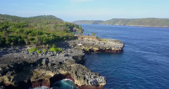 Aerial drone view of a rocky beach coastline alt