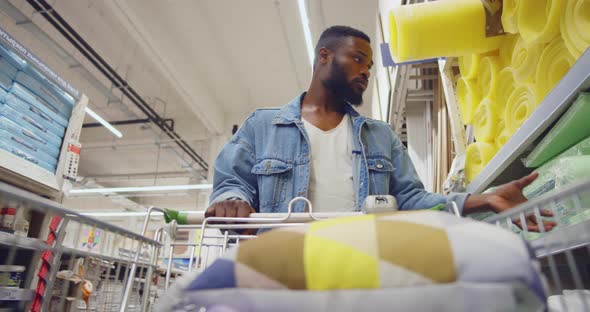 AfricanAmerican Man with Cart Shopping in Houseware Store alt