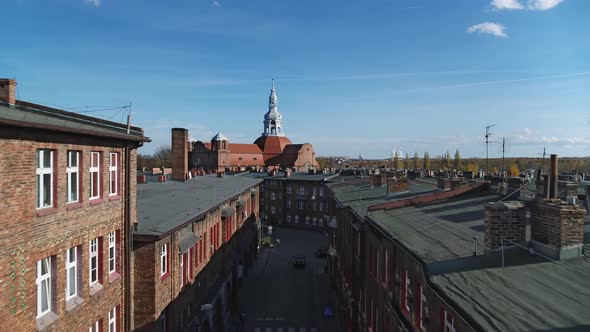 Old Red Brick Housing Estate with Historic Church in the Background