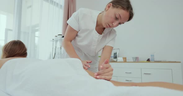 Female Massager Making Body Leg and Foot Massage and Lymphatic Drainage alt