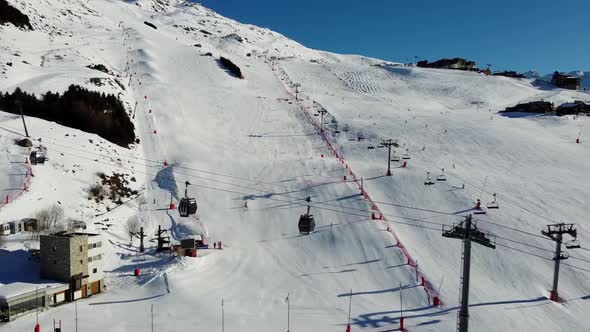 Aerial View of the Alps Mountains in France. Mountain Tops Covered in Snow. Alpine Ski Facilities