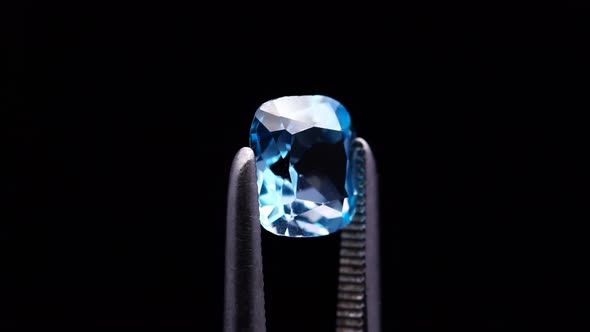 Natural Blue Topaz Cushion Cut in the Turning Tweezers