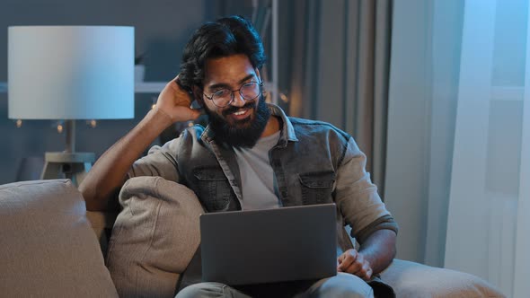 Arabic Indian Bearded Man Millennial Guy Businessman Freelancer Sitting at Home Sofa in Evening alt