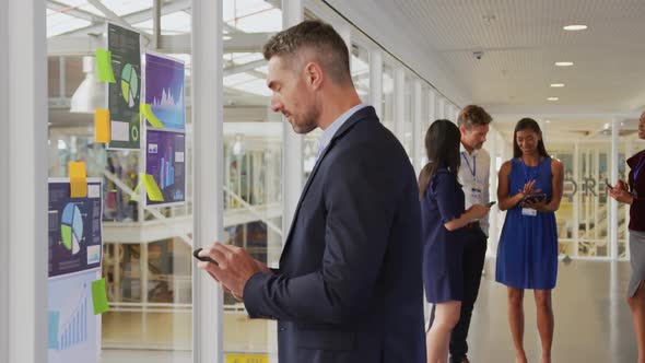 Businessman using smartphone at a conference alt