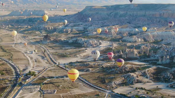 Hot air balloons flying over the valleys of Cappadocia near Goreme, Turkey alt