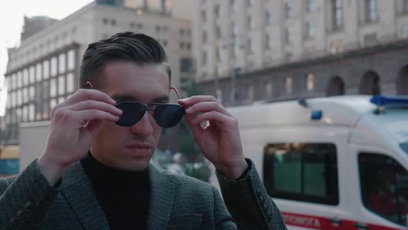 Successful Young Businessman Putting Sunglasses Looking Confidently Outdoors City alt