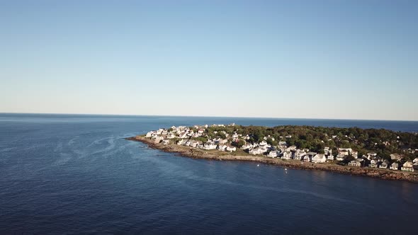 Aerial drone video of the ocean coastline and homes at Short Sands Beach near Cape Neddick and York, alt