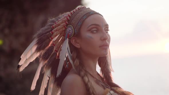 Cinematic Portrait of an American Indian Woman with Painted Makeup and Indian Culture Feather alt