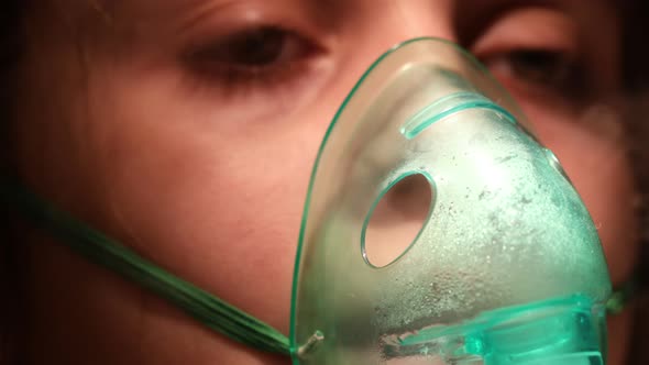 Child with a Mask From an Inhaler on His Face Closeup