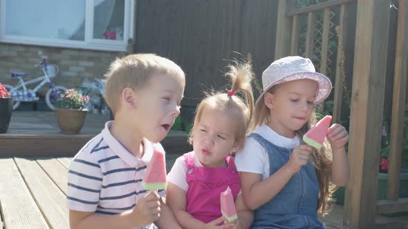 Three Cute Little Children Enjoys Delicious Ice Cream Cone