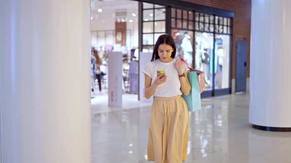 Beautiful Woman Using Online Navigation While Trying to Find Store in Mall alt