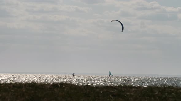 Two Kite Surfers Surfing at Sea a Sunny Day Copy Space Slow Motion