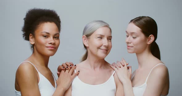 Caucasian Models with Large Age Differences Stand Beside AfricanAmerican Woman alt