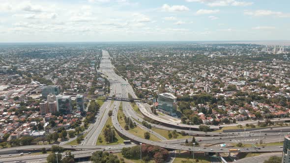 Aerial panning shot revealing Panamericana highway and General Paz avenue interchange alt