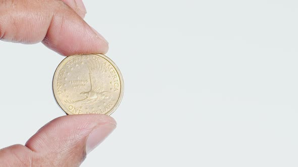 Fingers Hold A Bronze Us One Dollar Coin Front