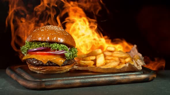 Super Slow Motion Shot of Hamburger, French Fries and Flames at 1000Fps. alt
