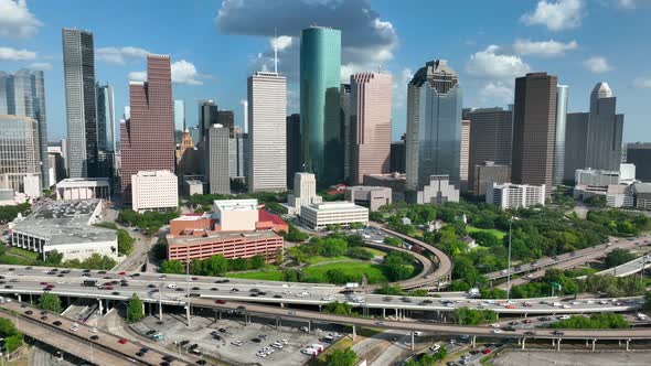 Houston Texas urban city skyline on bright sunny day. Interstate 45 commuter traffic drives on freew alt
