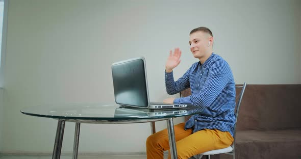 Guy Greeting Classmates and Teacher at Online Lesson alt