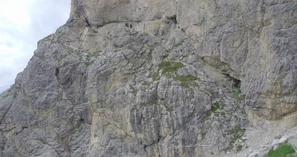 Aerial drone view of rocky mountains and a hidden cave alt